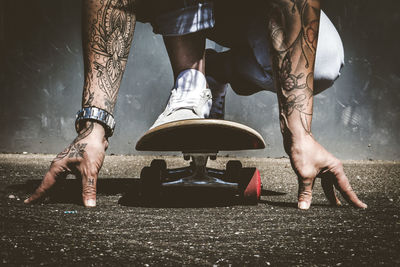 Tatooed person on a skateboard