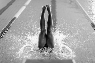 Low section of woman swimming in pool