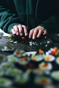 Midsection of person preparing food on table