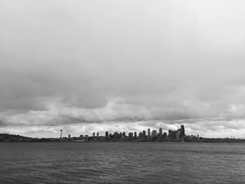 View of cityscape against cloudy sky