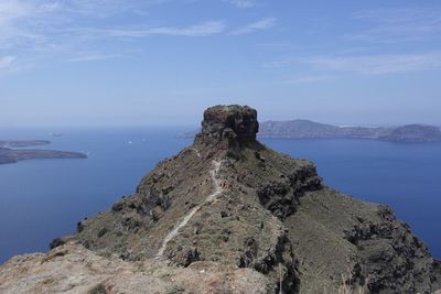 Rock formations by sea against sky