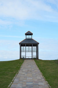 Built structure on field against sky