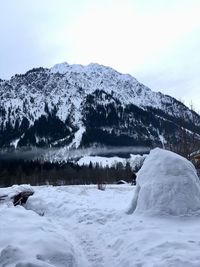 Scenic view of snow covered mountains against sky