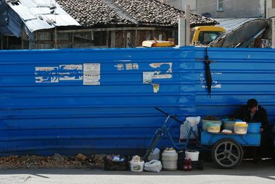 Men on blue vehicle