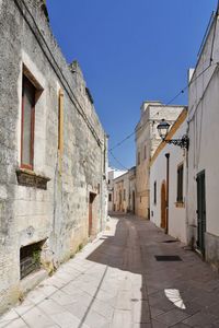 A small street between the old houses of presicce, a village in the province of lecce in italy.