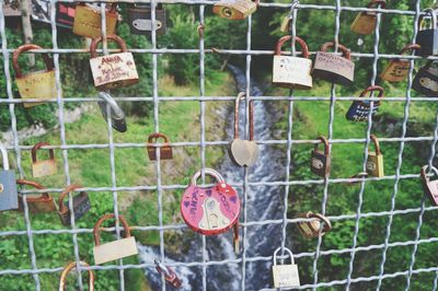 Close-up of padlocks hanging on railing