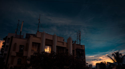 Low angle view of buildings against sky at night