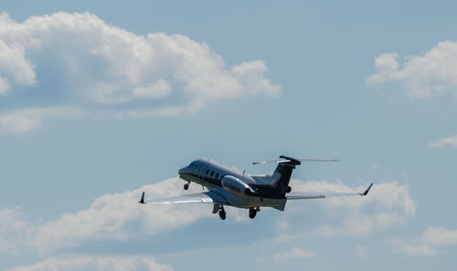 Low angle view of airplane flying in sky