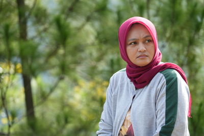 Portrait of young woman standing outdoors