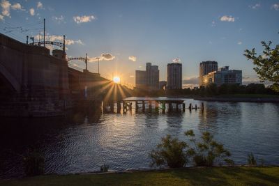 View of city at waterfront during sunset