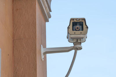 Low angle view of camera against clear sky