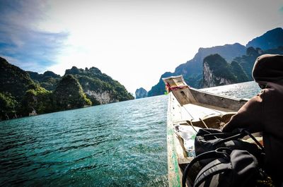 Boats in sea with mountain in background