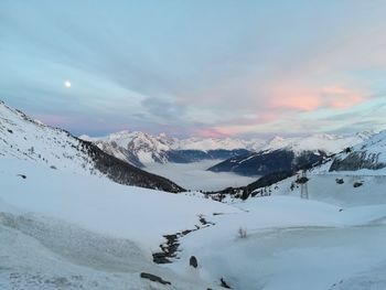 Scenic view of snow covered mountains against sky