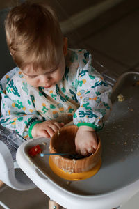 High angle view of cute baby girl eating food