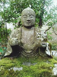 Statue of woman in garden