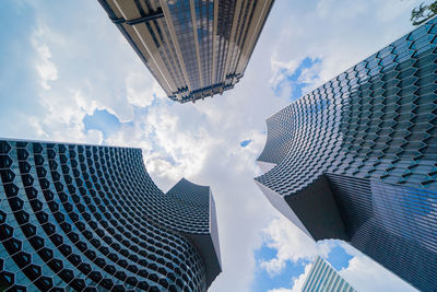Low angle view of buildings against cloudy sky