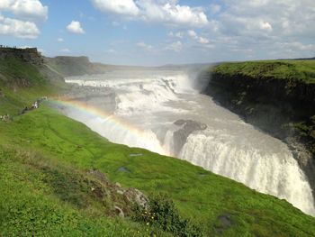 Scenic view of waterfall against sky