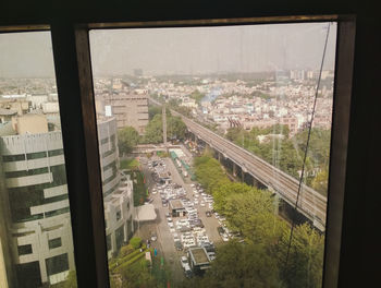 High angle view of city buildings seen through window