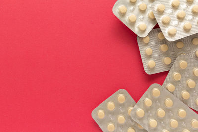 Close-up of medicines on red background