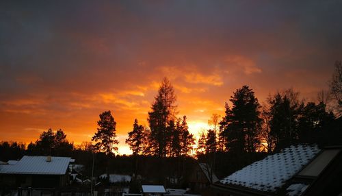 Houses against sky during sunset