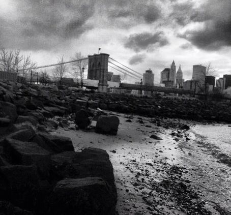 architecture, built structure, sky, building exterior, cloud - sky, cloudy, city, water, cloud, rock - object, weather, skyscraper, overcast, sea, beach, river, day, cityscape, outdoors, tower