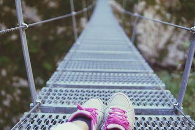 Low section of person on footbridge