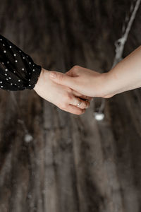 Cropped image of hands over wooden floor