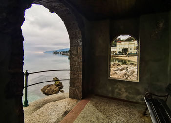 View of sea seen through window