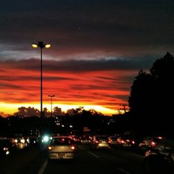 Traffic on road against sky at dusk