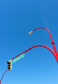 Low angle view of street light against blue sky