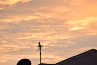 Low angle view of street light against cloudy sky