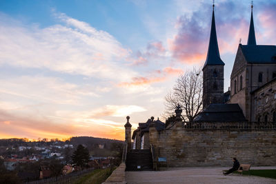 Michaelsberg abbey in town against sky during sunset