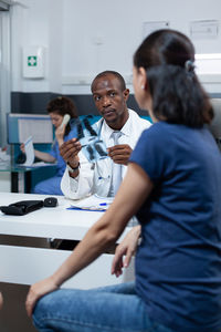 Doctor showing medical xray to patient in clinic