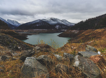 Scenic view of lake and mountains against sky