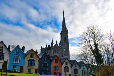 Low angle view of buildings against cloudy sky