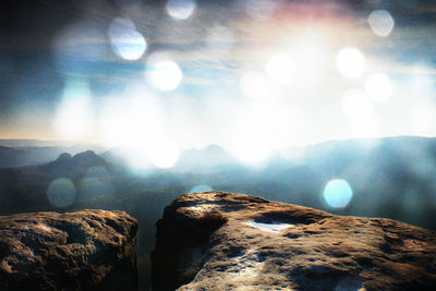 Scenic view of rocks against sky on sunny day