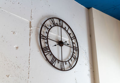 Low angle view of clock on wall