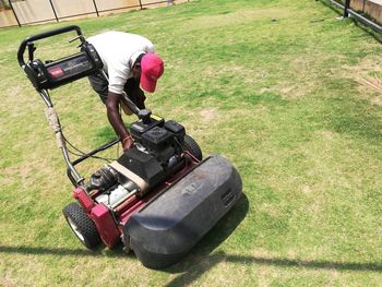 Man working on grassy field