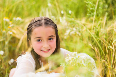 Portrait of girl sitting on field