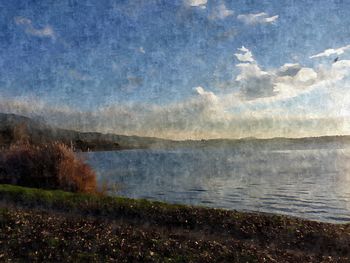 Scenic view of lake against cloudy sky