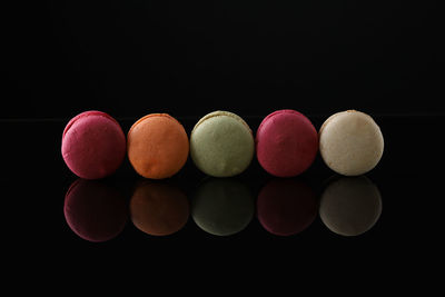 Close-up of macaroons against black background