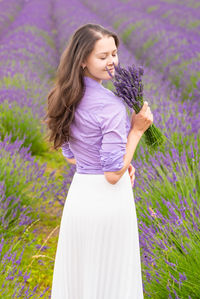 Rear view of woman standing on field