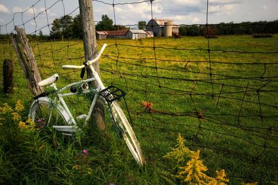 Bicycles on field against sky