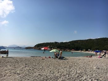 Scenic view of beach against blue sky