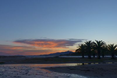 Scenic view of beach against sky during sunset