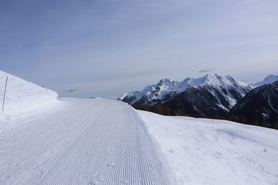 Scenic view of snow covered mountains against sky