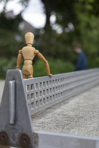 Close-up of figurine sculpture on railing