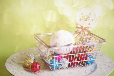 Close-up of baubles and candy in basket