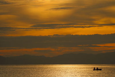 Scenic view of sea against orange sky