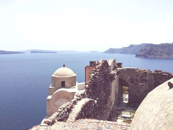 Town by sea against clear sky